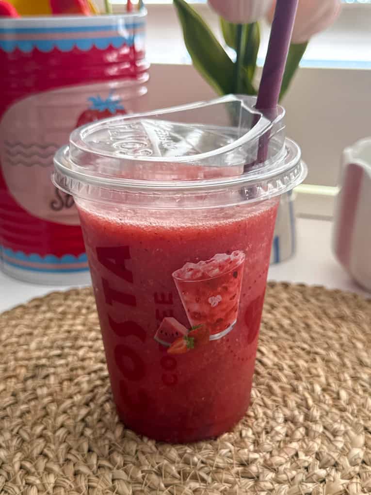 Strawberry, Watermelon & Mint Refresher served in a clear Costa plastic cup with a straw.