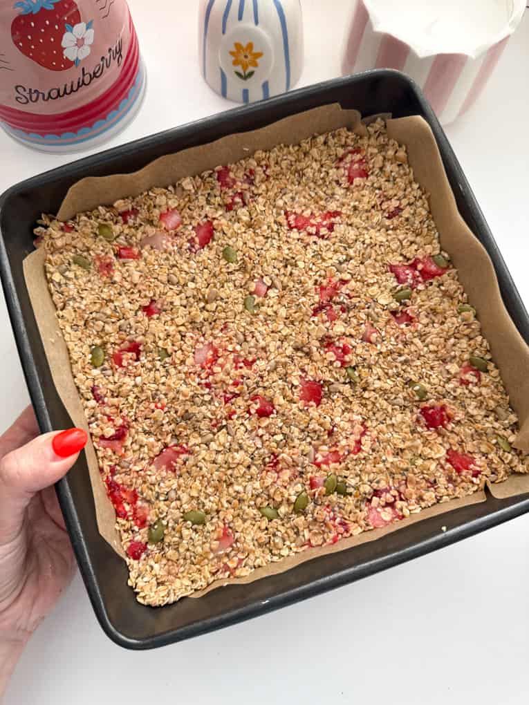 Strawberry oat bar mixed inn a oven proof dish, ready for baking.
