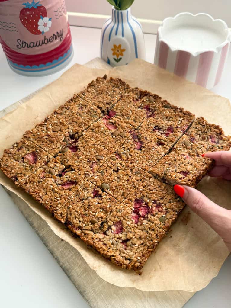 Strawberry oat bars fresh out of the oven and cut into even bite sized pieces.